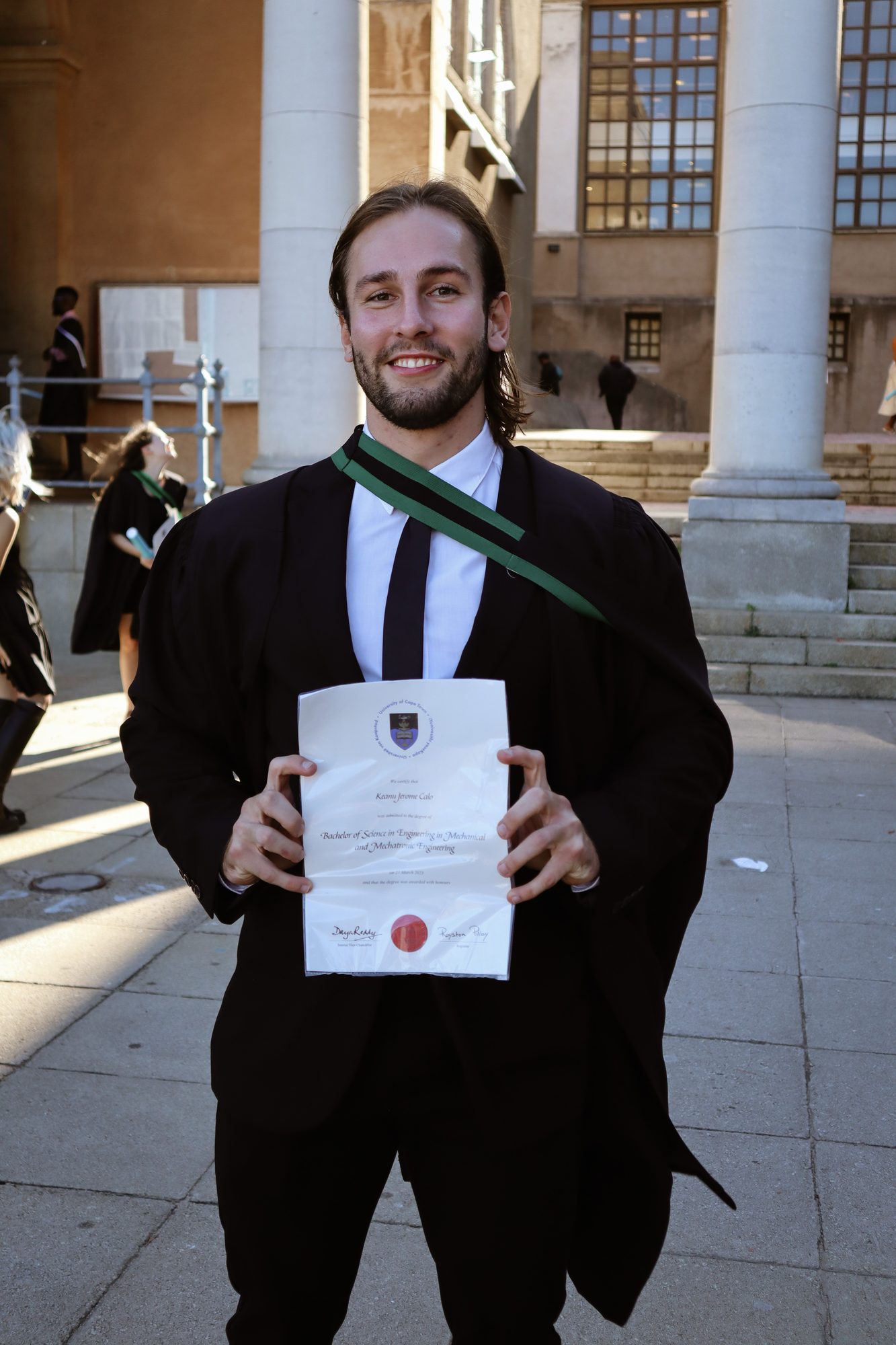Graduating from the University of Cape Town, holding the degree certificate